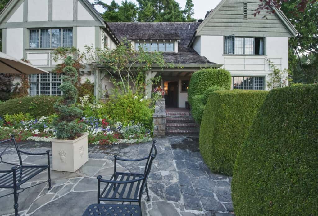 Beautiful landscaped front yard with stone pathway and lush greenery.